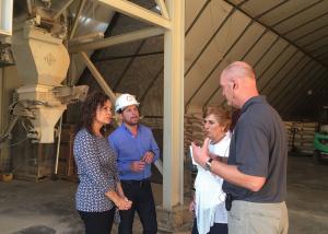 image of 4 People Talking In Front of Machine