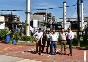 Six People standing in front of factory