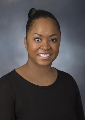 Woman in front of Gray Background Smiling