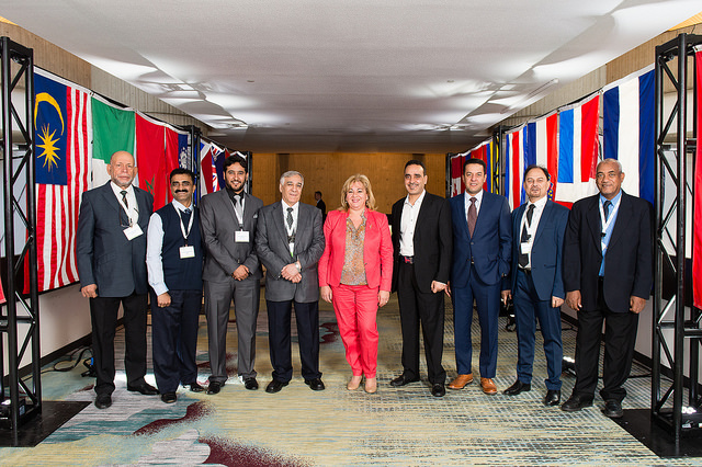 Nine People Standing Next To Flags
