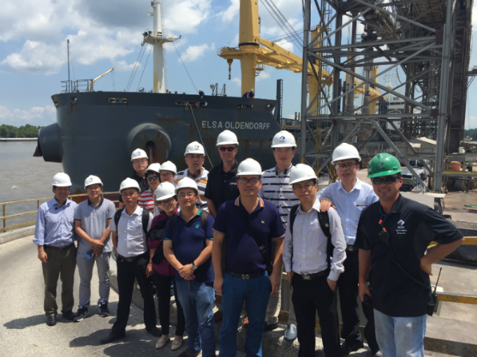 Fifteen People Standing In Front Of Boat