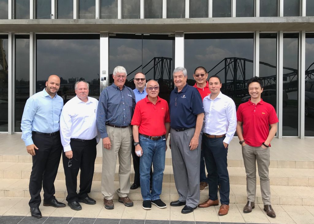 a group of men smiling for a photo in Malaysia