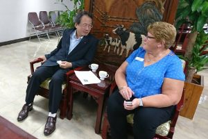 A man and a woman speaking in chairs