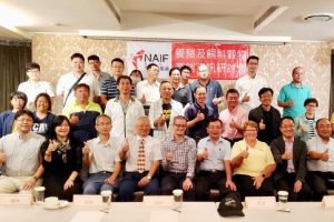 A group of Taiwanese hog farmers smiling for a picture