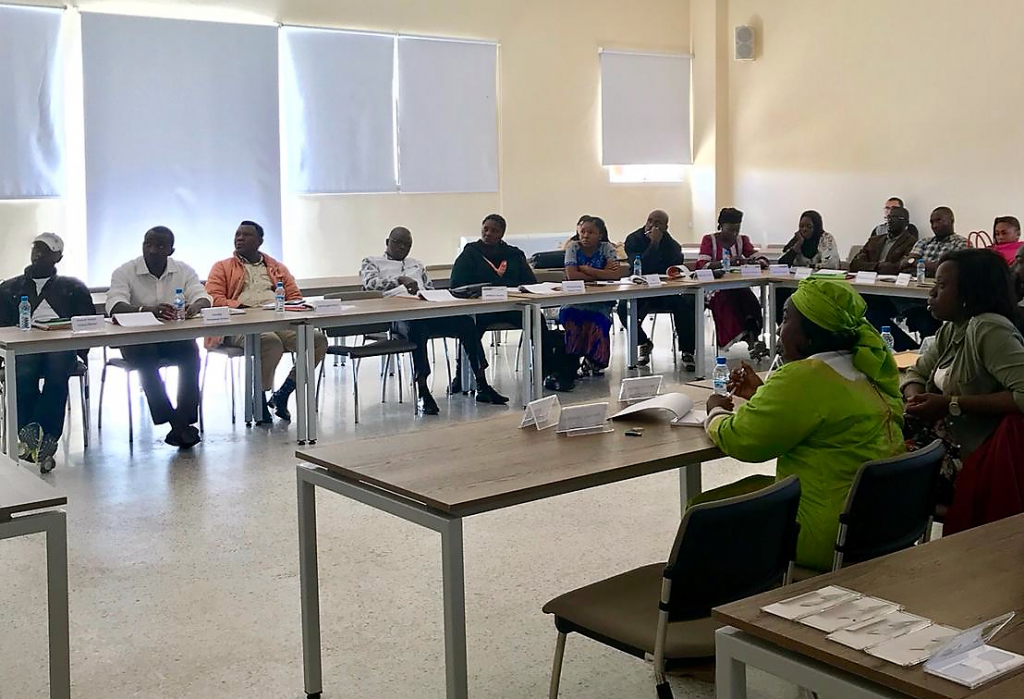 image of people in a conference room listening to a speaker