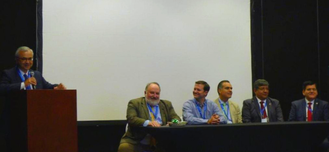 Man at Podium 5 Men Sitting at Table