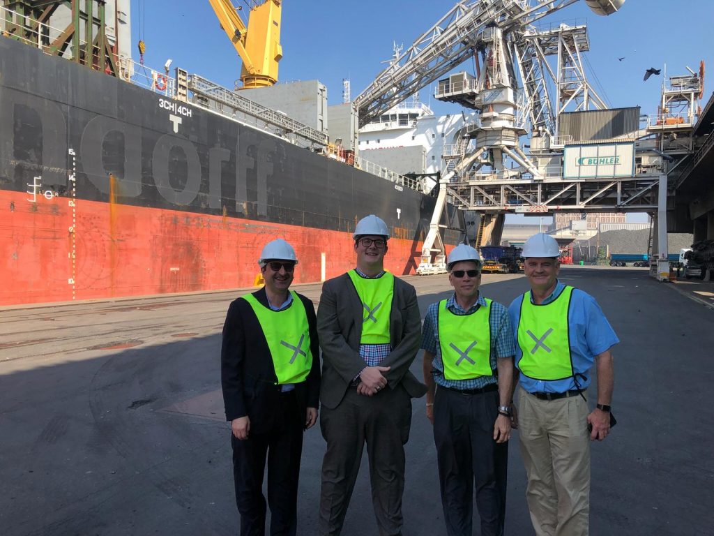 image of four men in hard hats at a port in South Africa