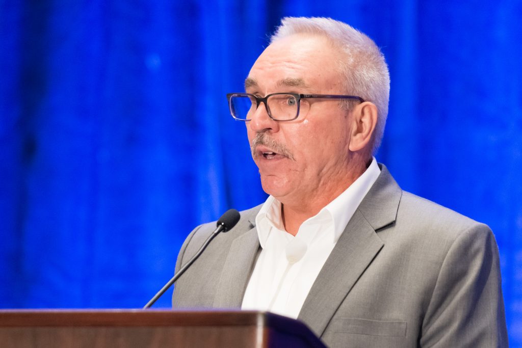 Scott Sindelar speaking at podium