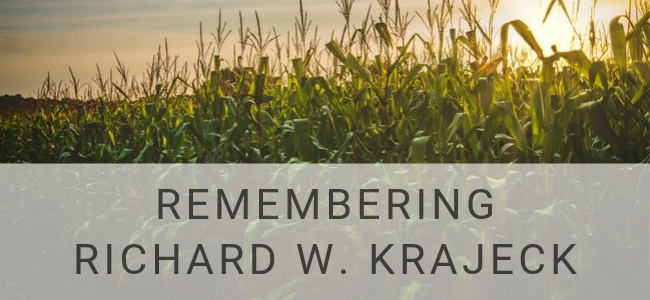 image of the sun setting on a corn field in memory of Richard W. Krajeck