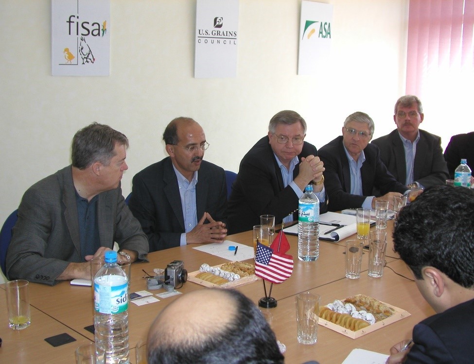 5 People Sitting Around Desk