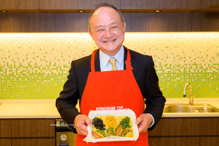 Man in Red Apron Standing for Picture
