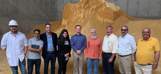 9 People Standing in Front of Pile of Substance