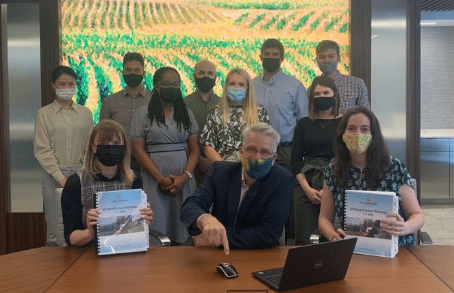 Eleven People Standing Behind Desk
