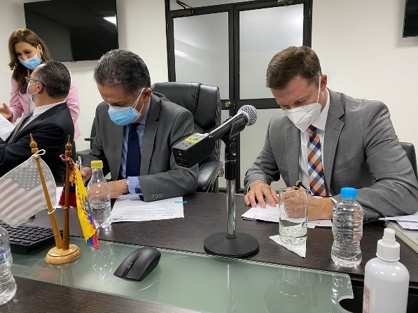 Men signing document