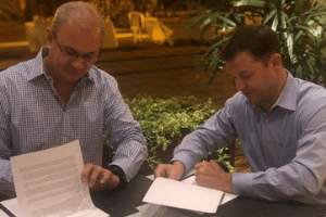 Men signing document