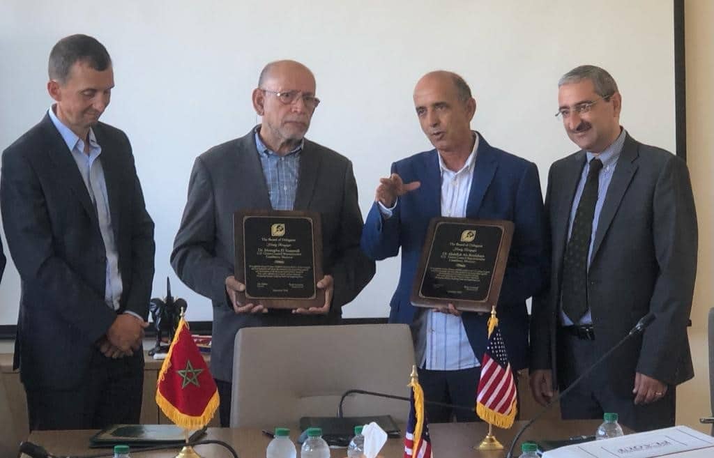 Four men taking a photo