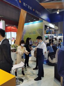 Two people discuss something at a trade show.