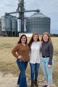 image of people in front of grain bins