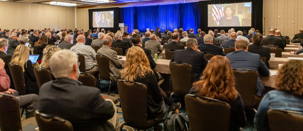 image of a room full of people listening to a presentation