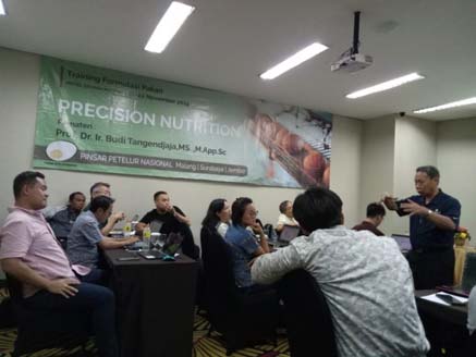 Image of people in a room listening to speaker