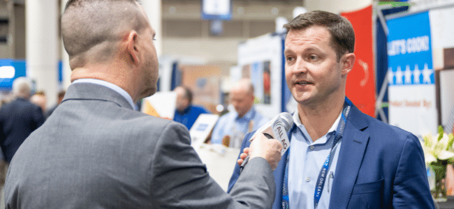 image of a man speaking to a reporter