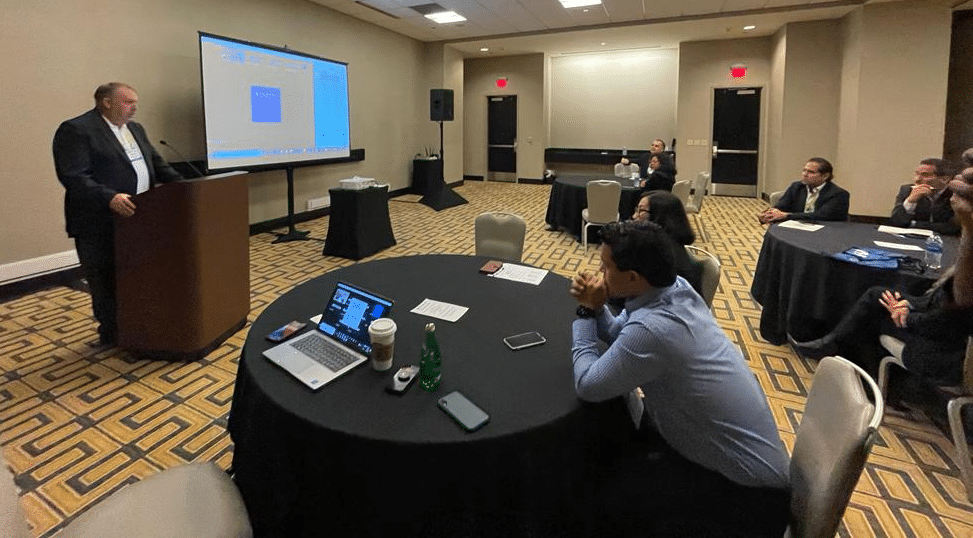 Image of people listening to man speak at podium