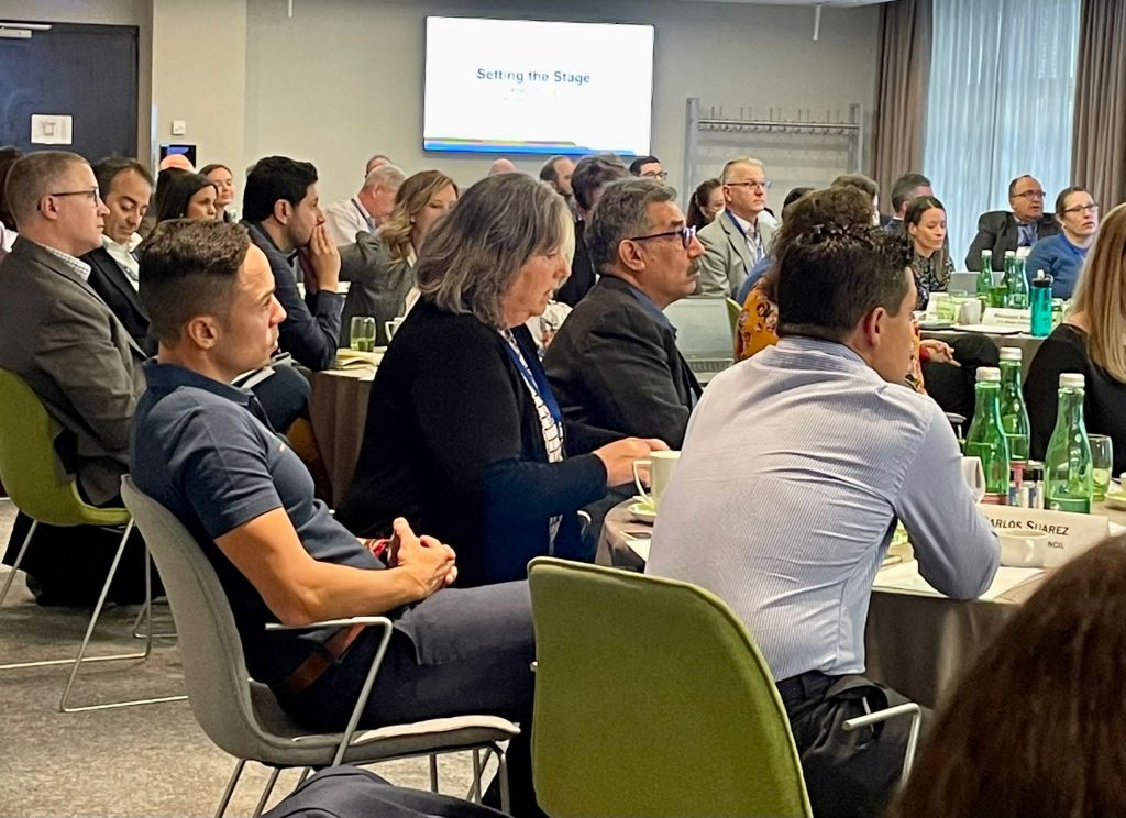 a group of people listening to a speaker at a conference