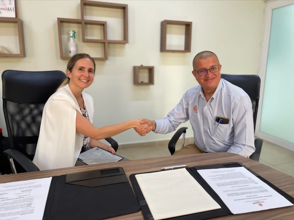 image of a woman and man shaking hands after signing a document