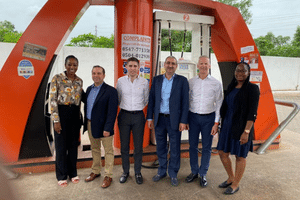 image of six people standing in front of a gas pump