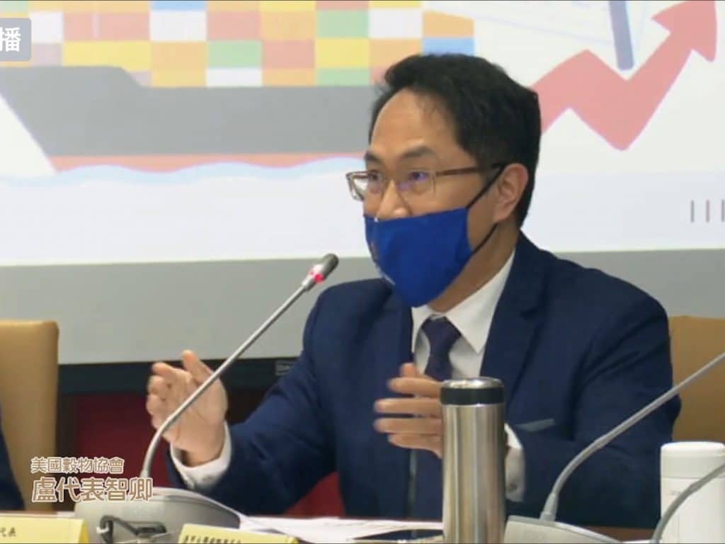 A man speaks into a microphone at a conference