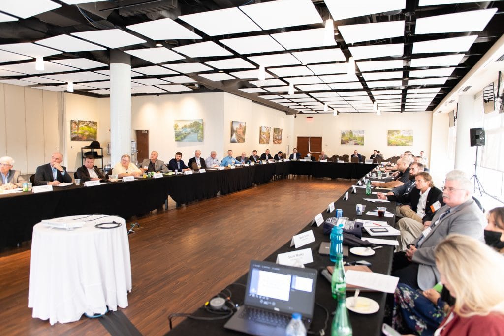 image of a group of people listening to a speaker at a conference