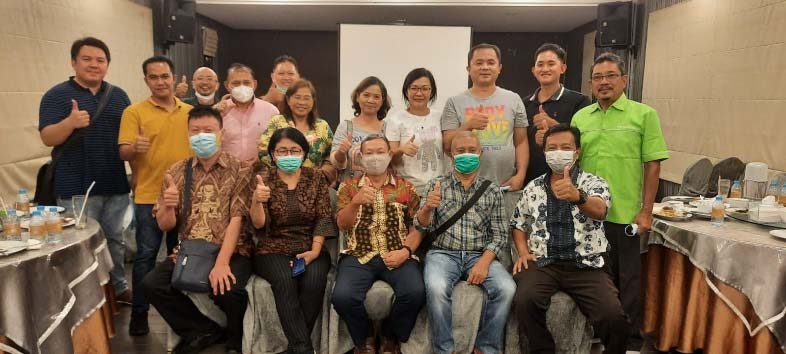 A group of people standing together giving thumbs up
