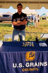 image of a man standing at a table smiling