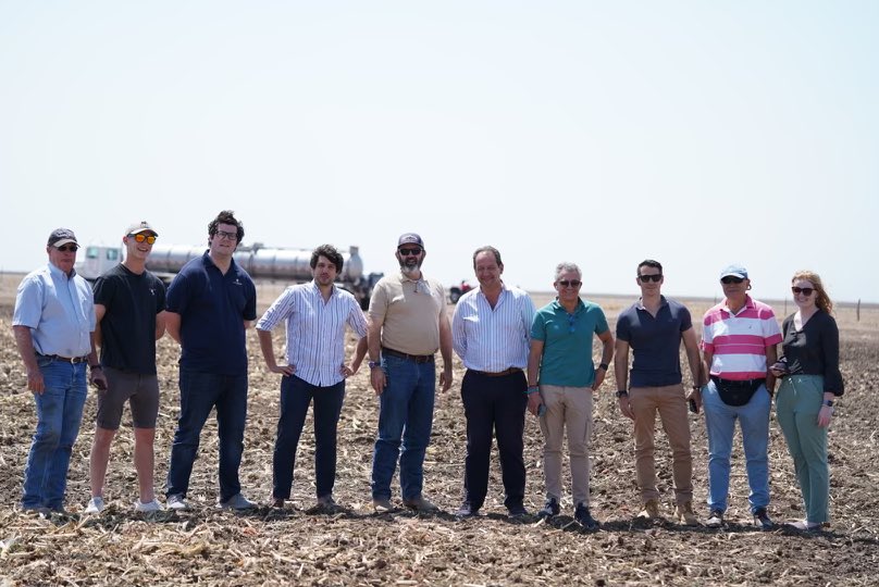 Group of people smiling for photo in a field