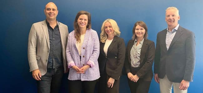 image of 2 men and three women smiling