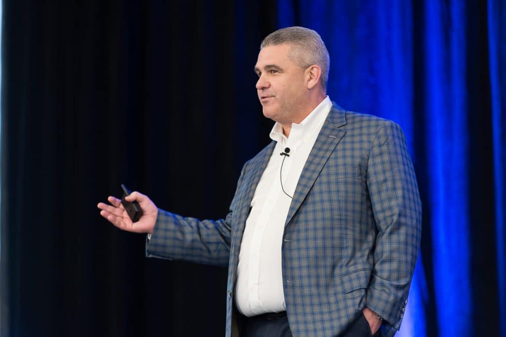A man speaking on a stage