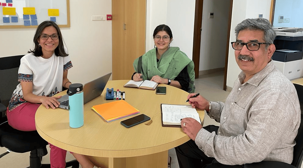 three people sitting at a desk