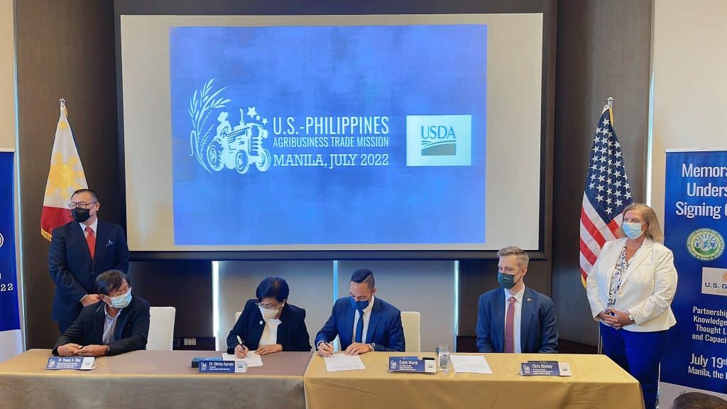 image of a group of people signing documents