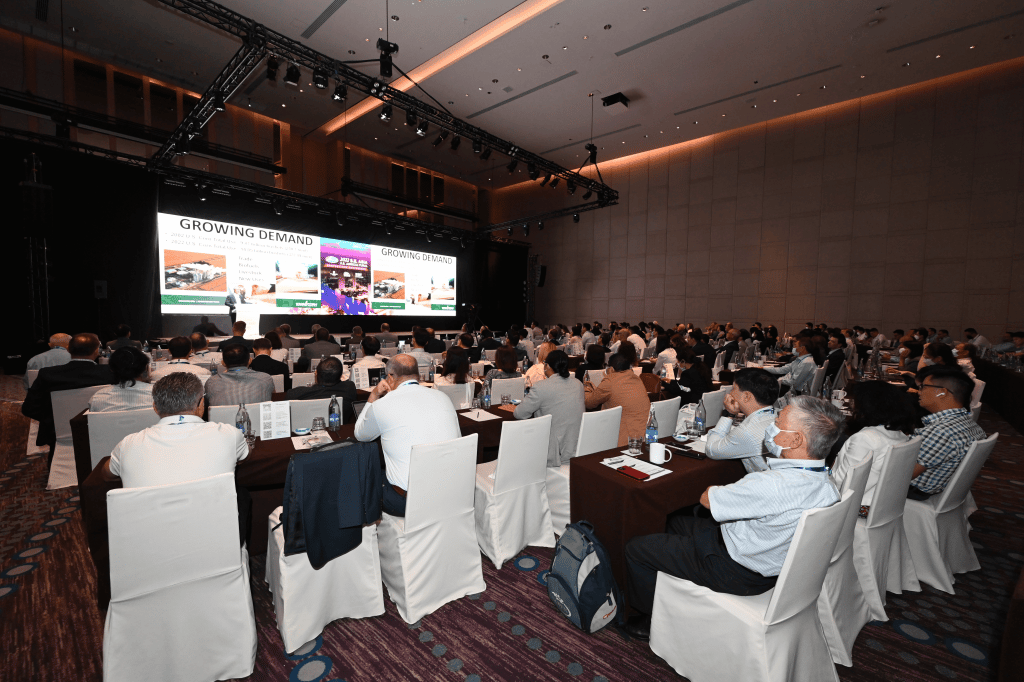 people listening to a presentation at a conference