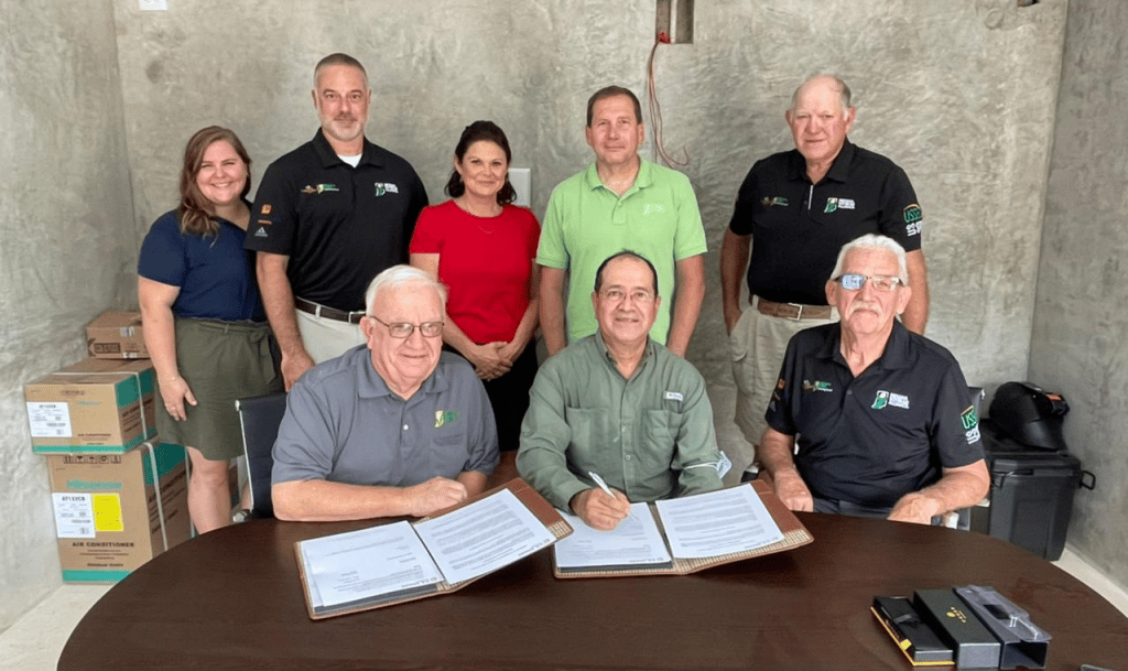 a group of people smiling at an MOU signing
