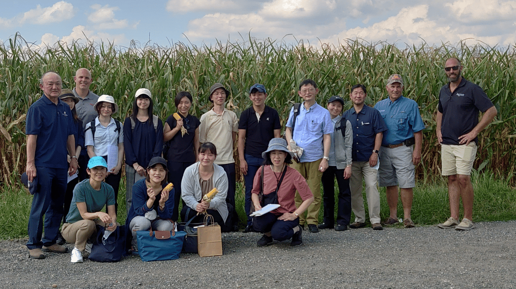 image of group of people in front of corn field