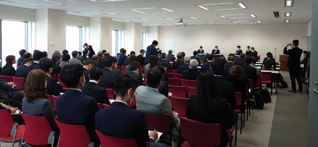 image of a panel speaking to room of people