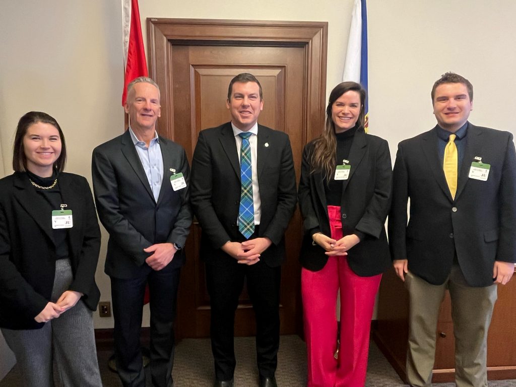 image of five people smiling for a photo