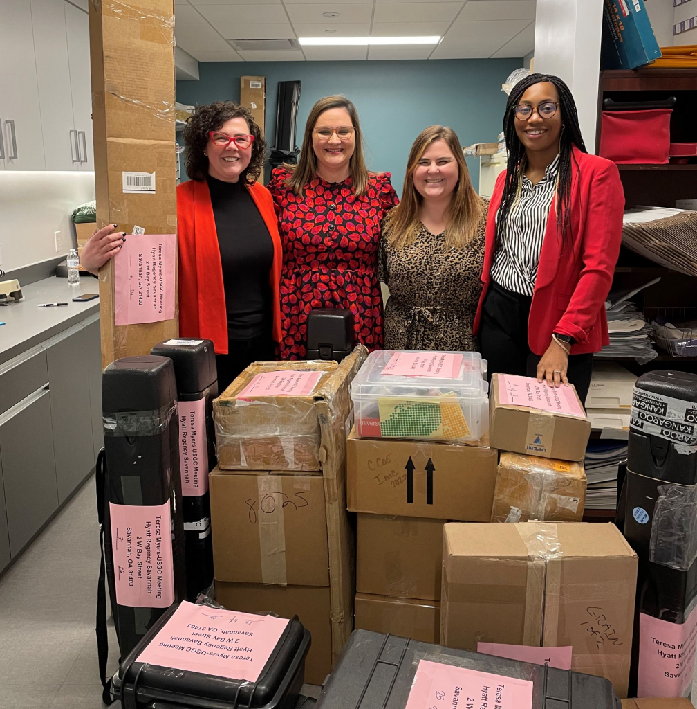 image of four women with shipping boxes