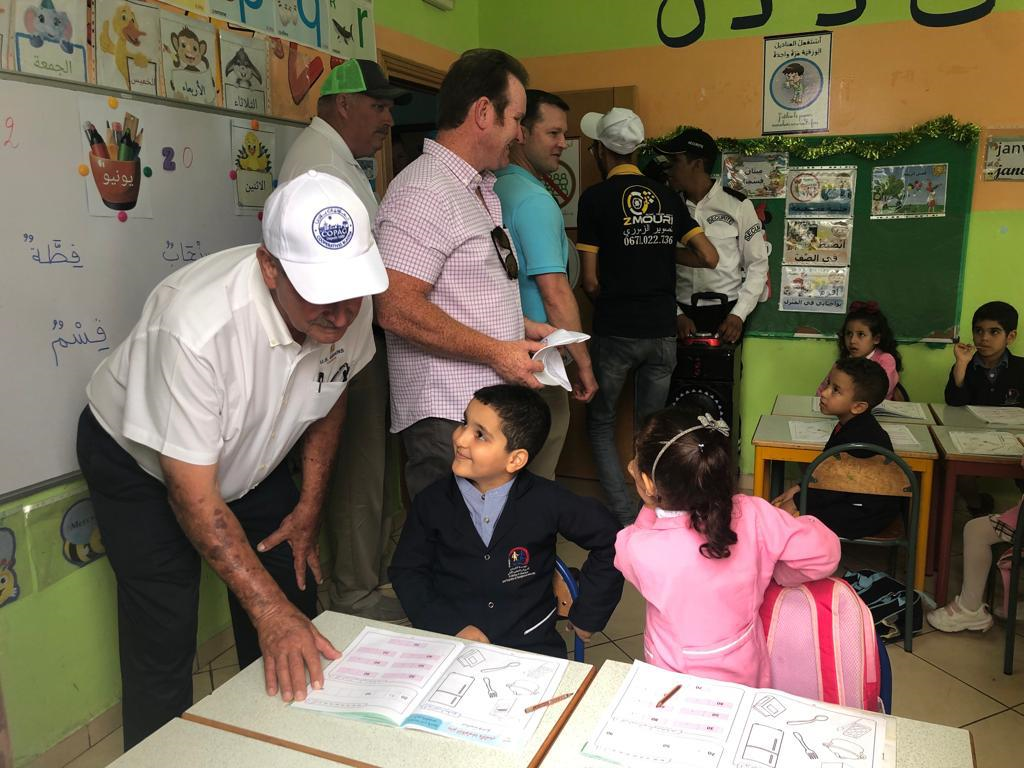 image of man talking to school children