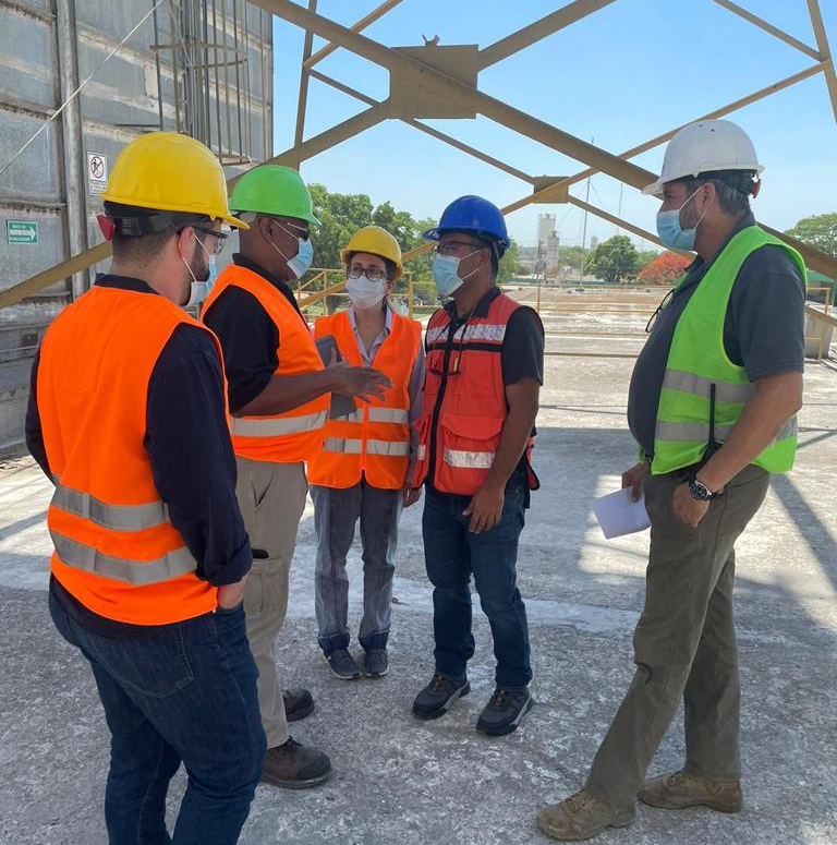 image of people in hardhats and masks talking to each other