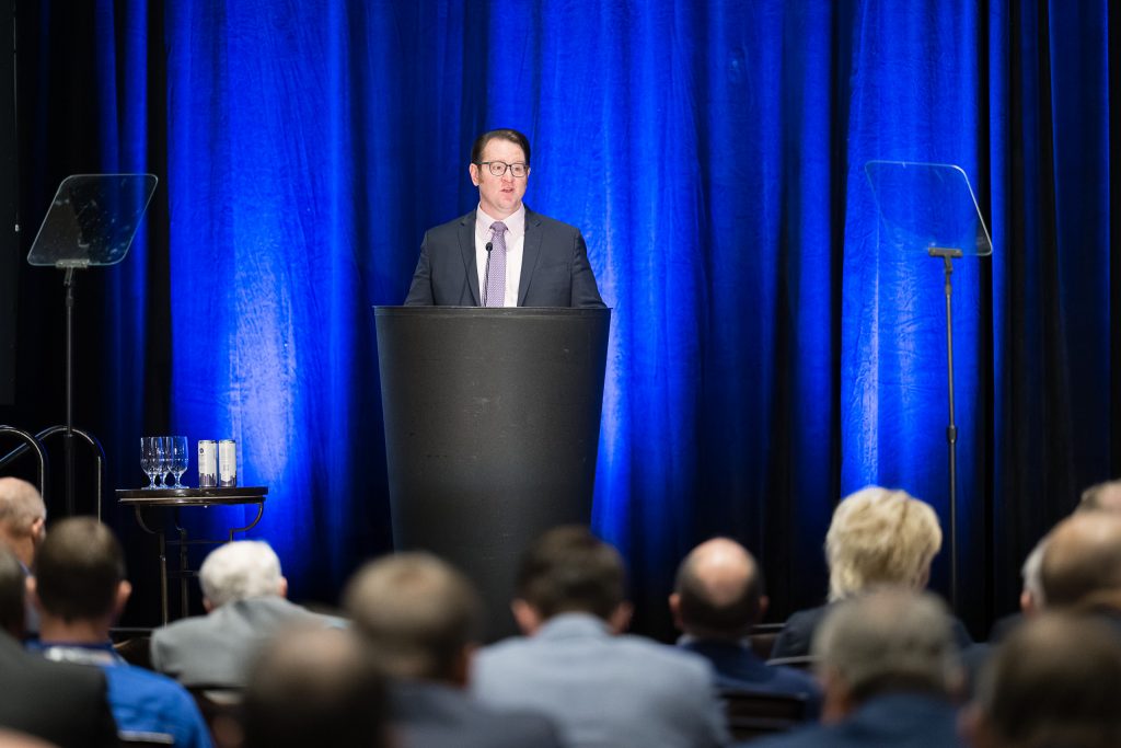 image of a man speaking at a podium