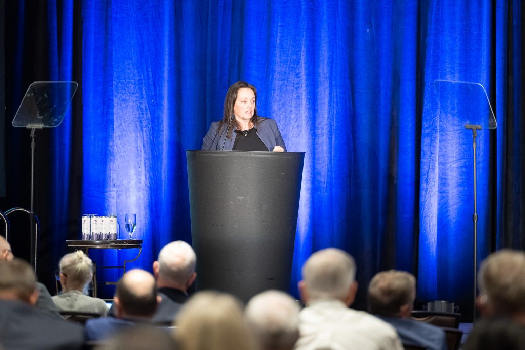 image of a woman speaking at a podium