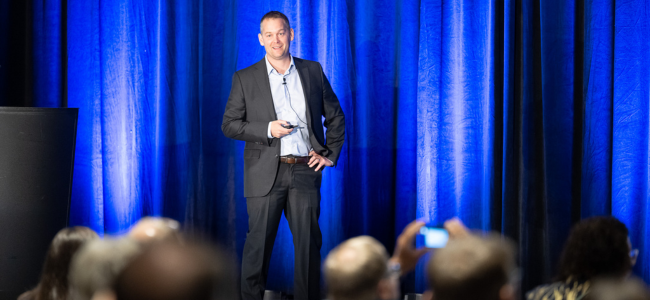 image of a man speaking on stage