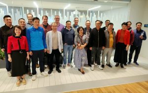 A large group of people posing for a photo in an office lobby